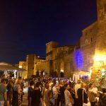 Pitigliano di notte durante Calici di Stelle 2025, con luci e pubblico nel centro storico